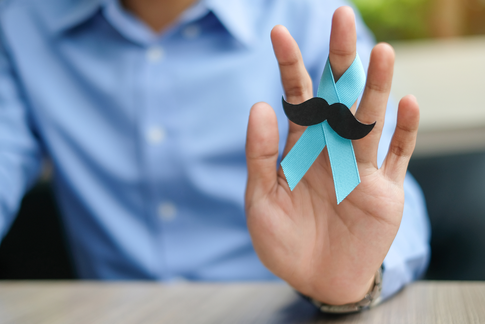 Prostate Cancer Awareness, Man Hand Holding Light Blue Ribbon Wi